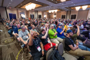 FSExpo 2023 Image, Attendees seen raising their hands