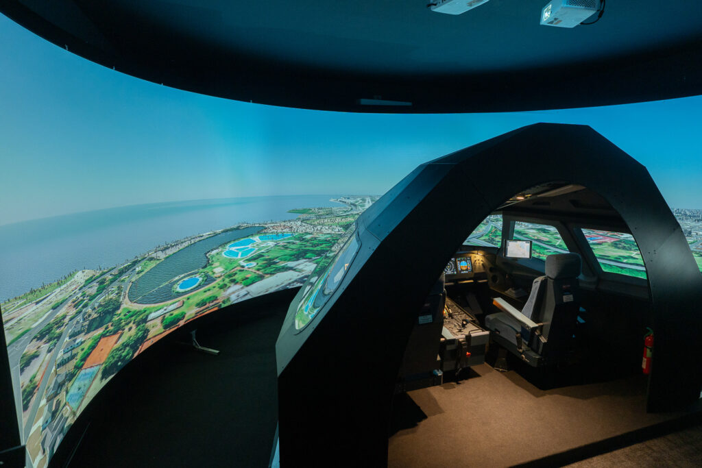 Toliss Professional A320 Simulator cockpit and projector screen.
