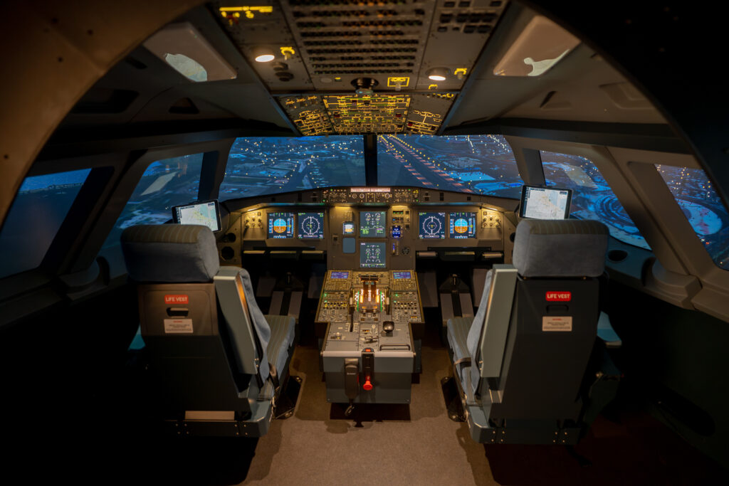ToLiss Professional A320 Simulator cockpit at night.