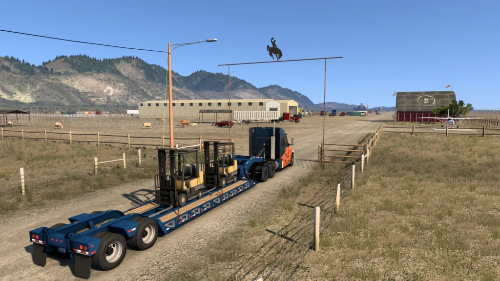 A semi truck and trailer loaded with fork-lift's at the entrance to the Circle B ranch