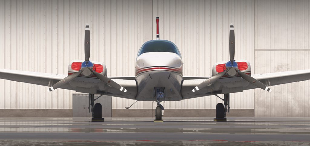 The Carenado B55 parked in front of a hangar.
