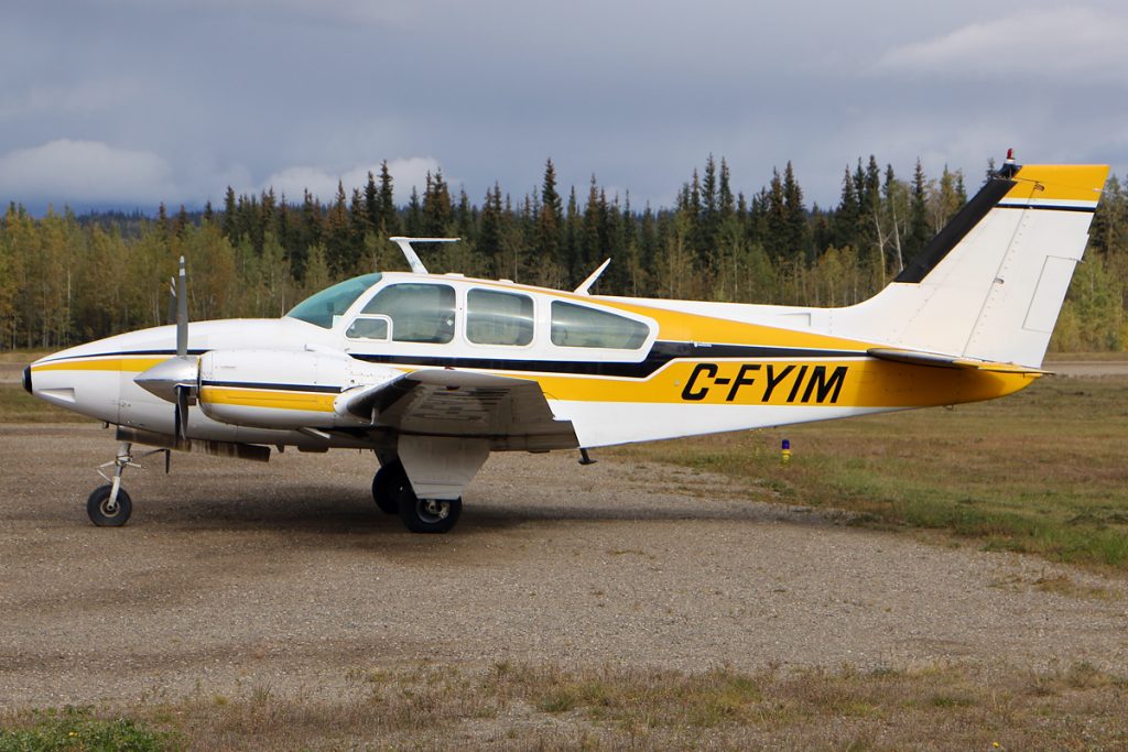 An image of the Beechcraft Baron 55 registered as C-FYIM parked at a Canadian airstrip.