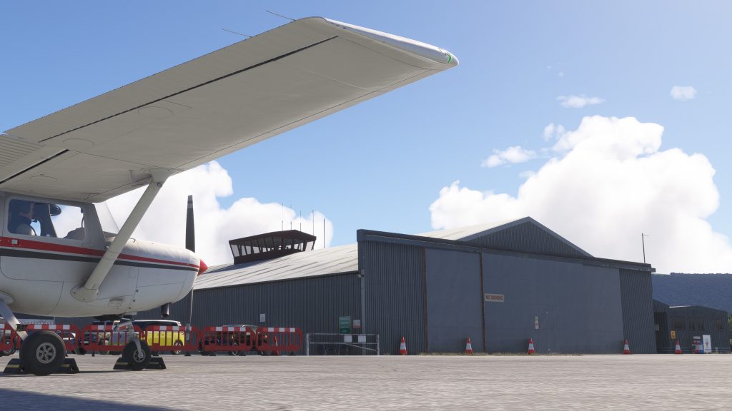 Burning Blue Design's Welshpool airport for MSFS 2020 and MSFS 2024 in sim view of the GA apron with Cessna 152, hangar and control tower.