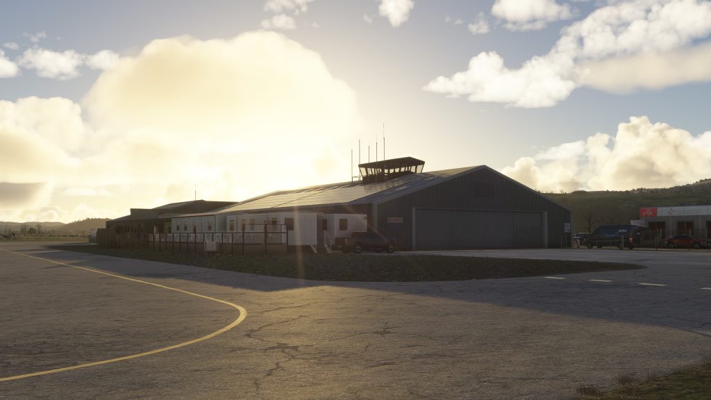 Burning Blue Design's Welshpool airport for MSFS 2020 and MSFS 2024, beautiful sunset view of the main hangar and control tower. 