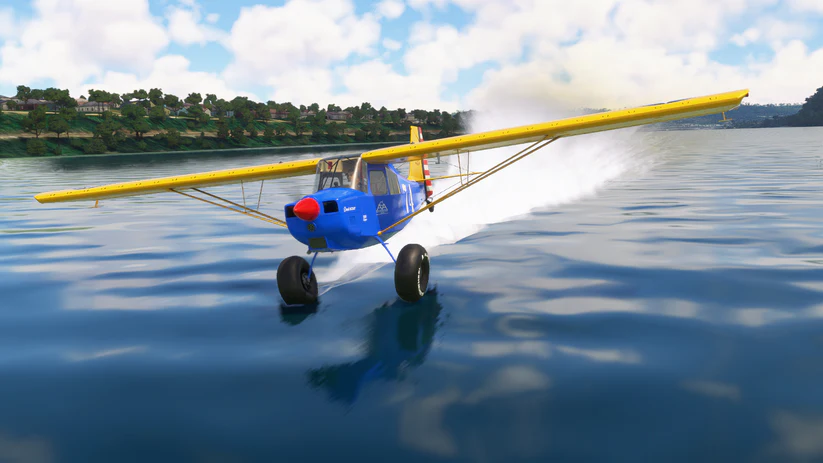 The STOL aircraft, the American Champion Scout, skimming the water.