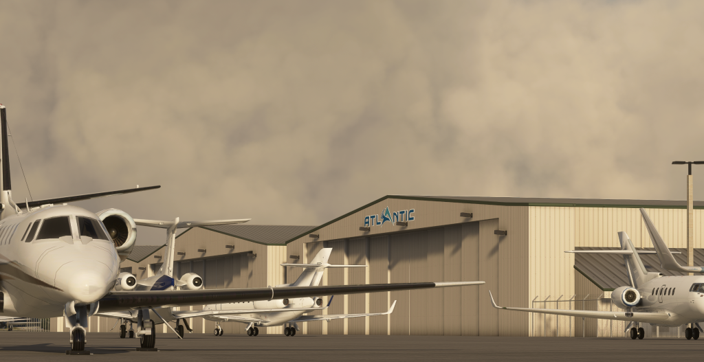 Insim night view of VerticalSim's Palm Beach international airport's GA apron and maintenance hangars with business jets parked.  
