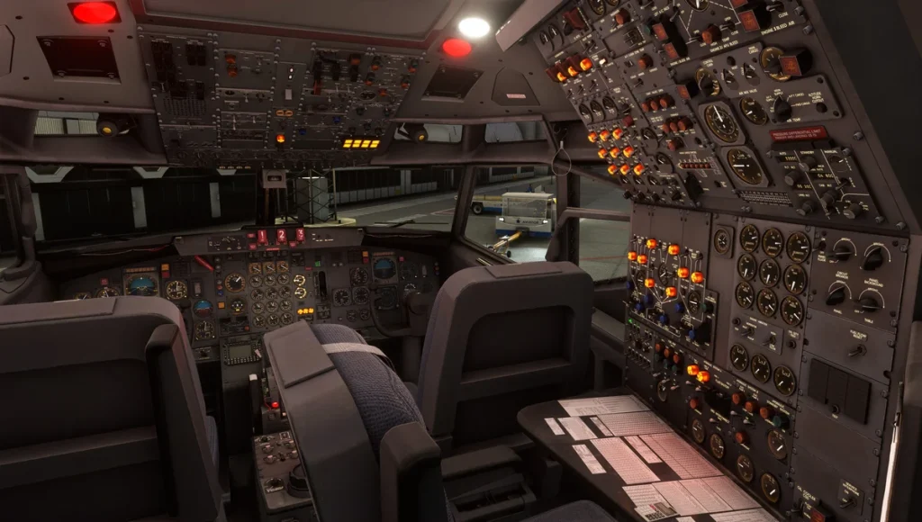 Full night cockpit view of the Boeing 727 showing captain, first officer, and flight engineer positions illuminated by instrument lighting