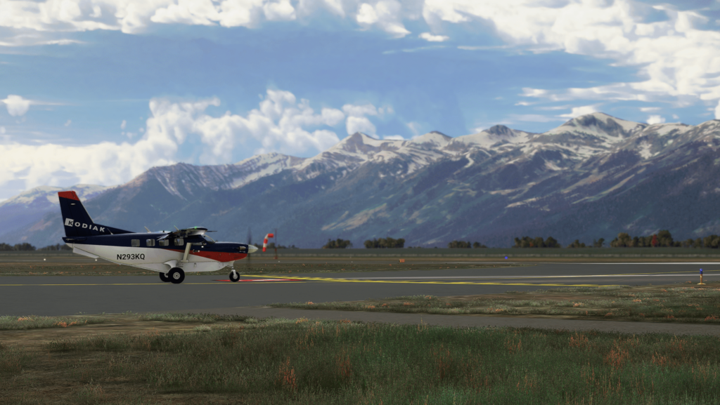 Kodiak 100 Series II taking off from a regional runway with mountainous scenery in Microsoft Flight Simulator 2024