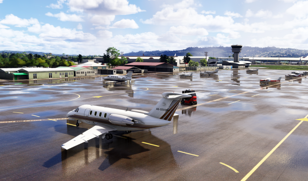 Martinique Aim&eacute; C&eacute;saire International Airport apron with aircraft parked on wet tarmac.