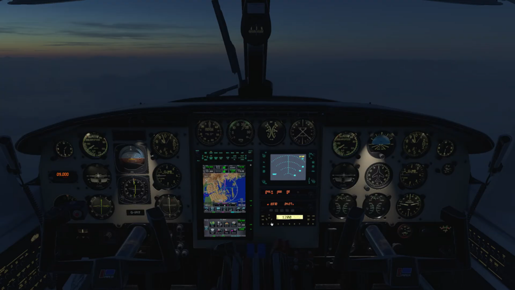 Cockpit at dusk with illuminated instruments and avionics during night flight