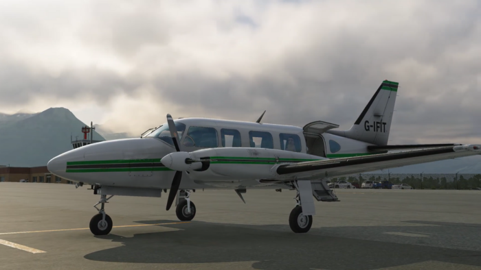 CIS Piper Chieftain parked on an airport ramp with mountains and cloudy sky in the background