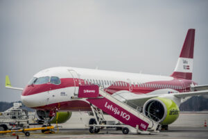 airBaltic Airbus A220-300 in the Latvia 100 special livery parked on the airport apron