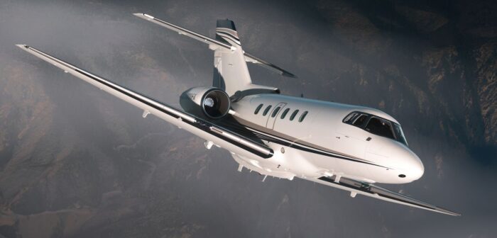 FlightFX Hawker 800XP banking over mountainous terrain in Microsoft Flight Simulator 2024